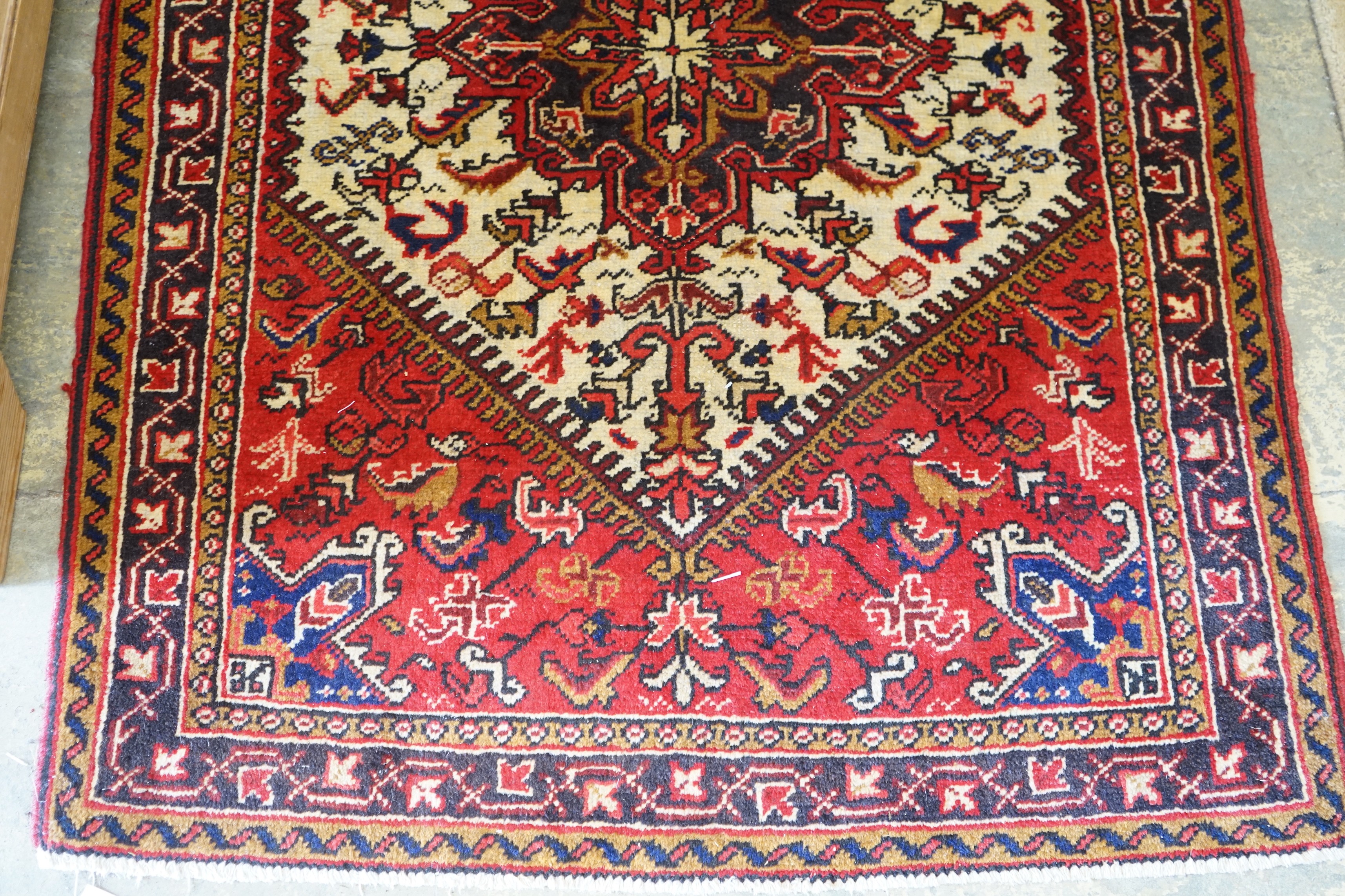 A Heriz ivory ground rug, 148 x 110cm